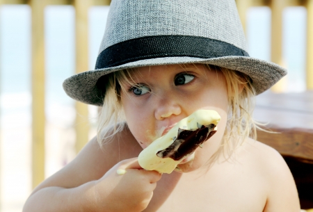 cute girl in the hat eating ice-creamの写真素材