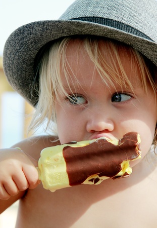 cute girl in the hat eating ice-creamの写真素材