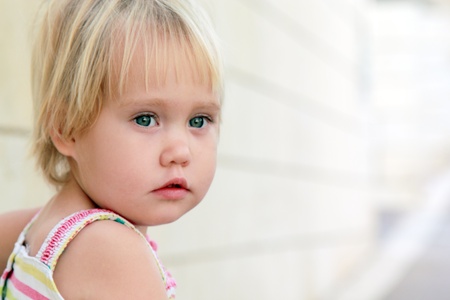 Cute little girl outdoors in city streetの写真素材