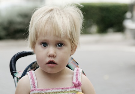 Cute little girl outdoors in city streetの写真素材
