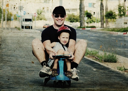 Father and son playing together. Photo in old image styleの写真素材