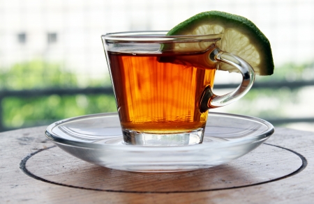 cup of tea with lemon standing on wooden tableの写真素材