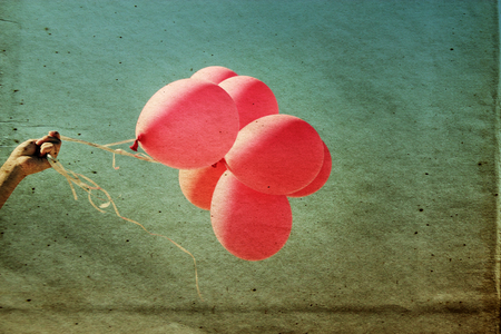 red balloons on the vintage textured skyの写真素材