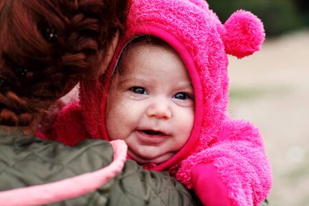 young mother with her two month baby outdoorの写真素材