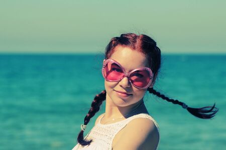 Portrait of beautiful fashion woman with pink sunglasses