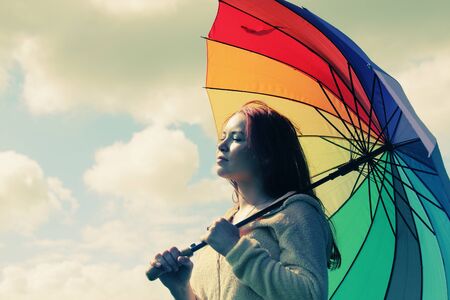 Woman with umbrella. Photo in old color image style.