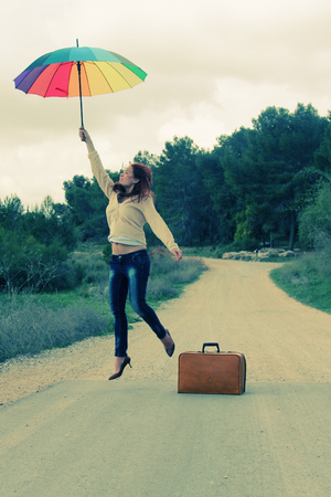 Woman with umbrella. Photo in old color image style.の写真素材