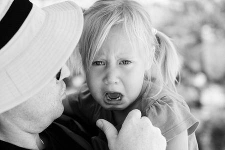 Angry upset girl with fatherの写真素材