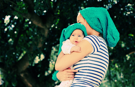 Portrait of happy loving mother and her baby outdoors