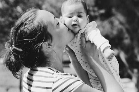 Portrait of happy loving mother and her baby outdoors