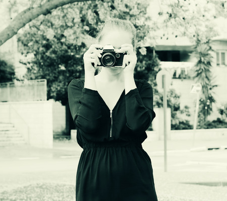 woman with old vintage camera outdoors