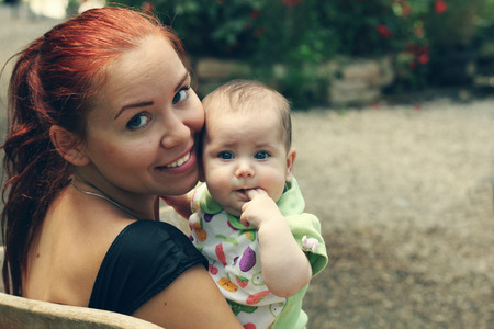 Portrait of happy loving mother and her baby outdoors