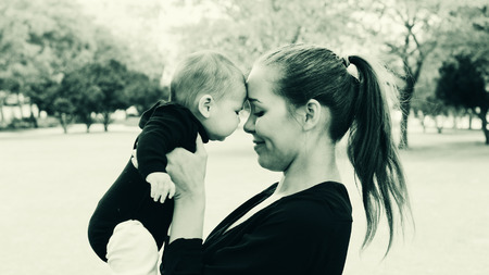 Portrait of happy loving mother and her baby outdoors
