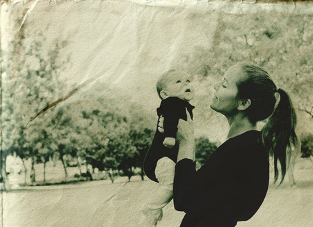 Portrait of happy loving mother and her baby outdoorsの写真素材