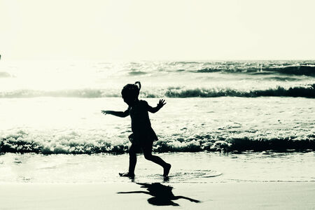 girl playing on the beachの写真素材