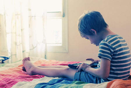 Cute boy using a laptopの写真素材