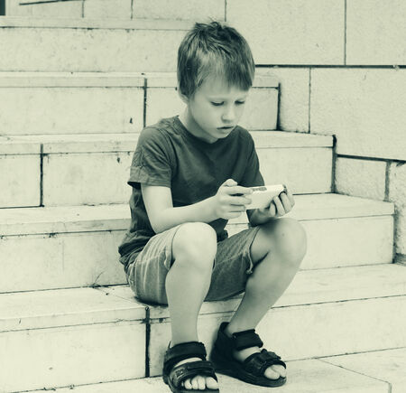 Cute boy using a mobile phone