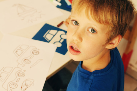 cute 6 years old boy drawingの写真素材