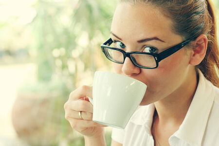 young girl with a cup of coffeeの写真素材