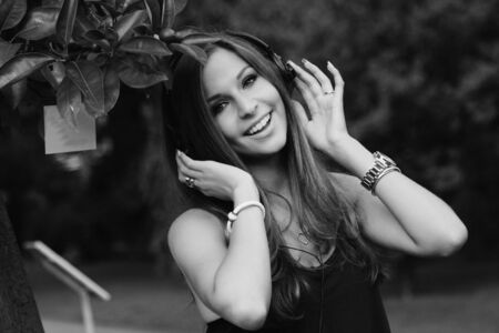 Beautiful Young Woman with Headphones Outdoorsの写真素材