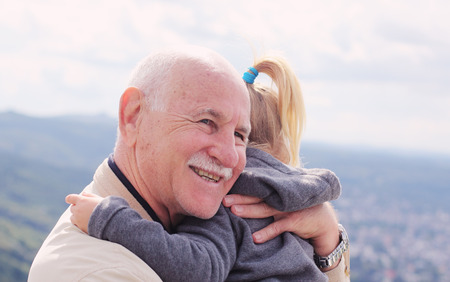 grandfather holding his 3 year old granddaughter