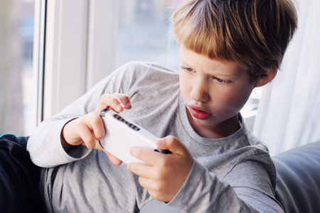 Cute boy using a mobile phone