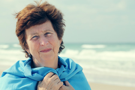 Portrait of happy senior woman at seaの写真素材
