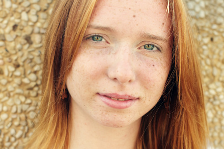 Closeup portrait of beautiful young redhead girl