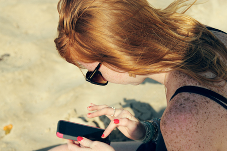 young woman holding smartphoneの写真素材