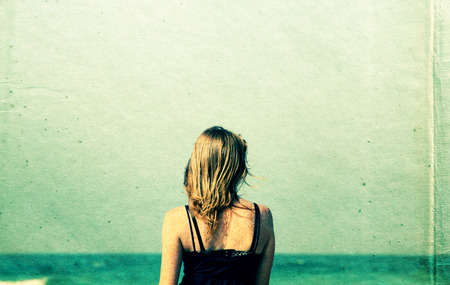 Beautiful young woman walking at the beach. の写真素材
