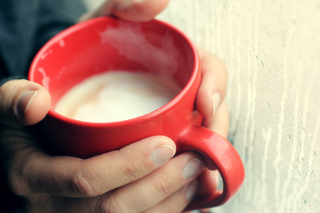 woman holding cup of coffeeの写真素材