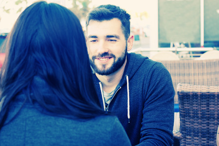 young couple relaxing together in street cafeの写真素材