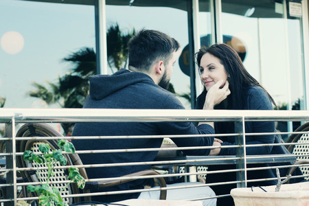 young couple relaxing together in street cafeの写真素材
