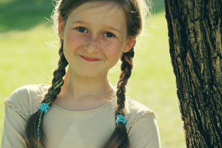 portrait of a beautiful happy smiling girl outdoorsの写真素材