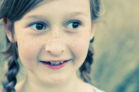 portrait of a beautiful happy smiling girl outdoorsの写真素材