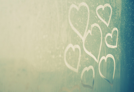 drawing hearts on wet window