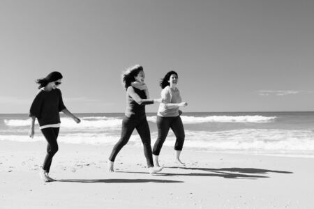Three best friends walking at seaside