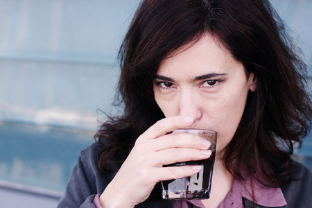 Portrait of beautiful 35 years old woman drinking coffeeの写真素材