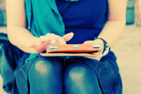 close up woman's hands with tabletの写真素材