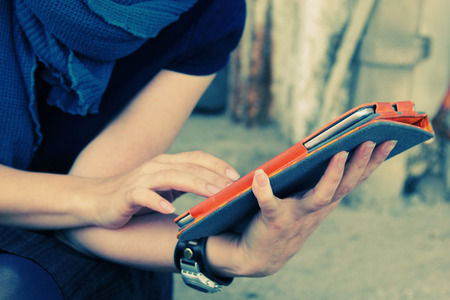 close up woman's hands with tablet