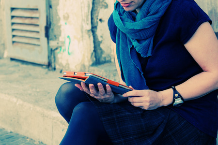 Close up woman\'s hands with tabletの写真素材