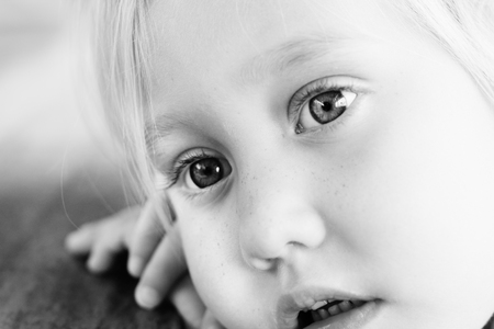 Adorable 4 years old girl sitting in cafeの写真素材