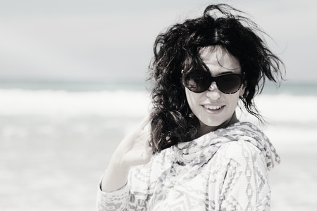 beautiful woman walking on seasideの写真素材