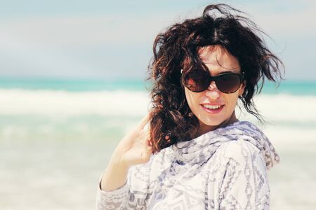beautiful woman walking on seasideの写真素材