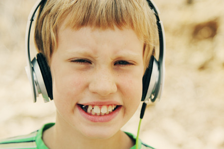 Portrait of cute autistic boy with headphonesの写真素材