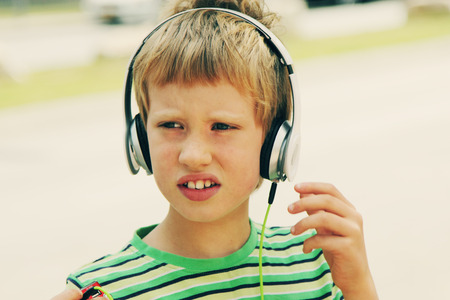 Portrait of cute autistic boy with headphonesの写真素材