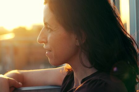 Portrait of beautiful 35 years old woman on sunset colorsの写真素材