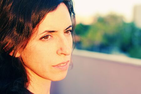Portrait of beautiful 35 years old woman on sunset colorsの写真素材
