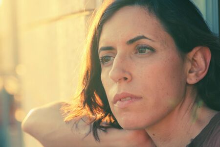 Portrait of beautiful 35 years old woman on sunset colorsの写真素材