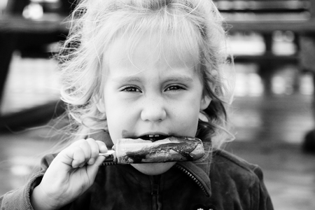 cute 4 years old girl eating ice creamの写真素材